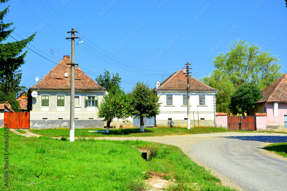 Fototapeta premium Typical rural landscape and peasant houses in Bruiu - Braller, a commune in Sibiu County, Transylvania, Romania. The settlement was founded by the Saxon colonists in the middle of the 12th century