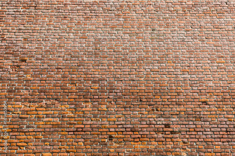Naklejka premium red brick wall texture grunge background with vignetted corners, may use to interior design