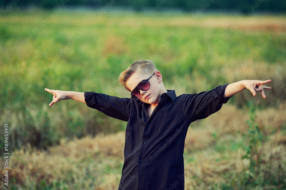 fashionable , stylishly dressed boy posing in nature fashionable , stylishly dressed boy posing in nature