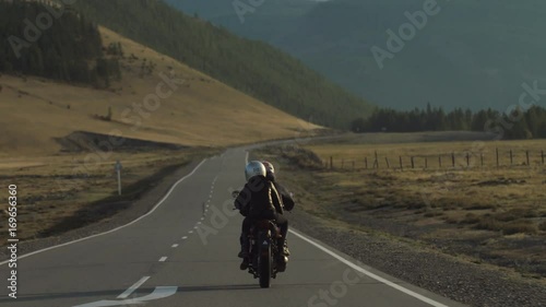 Couple of Motorcyclists are Driving along a Mountain Road