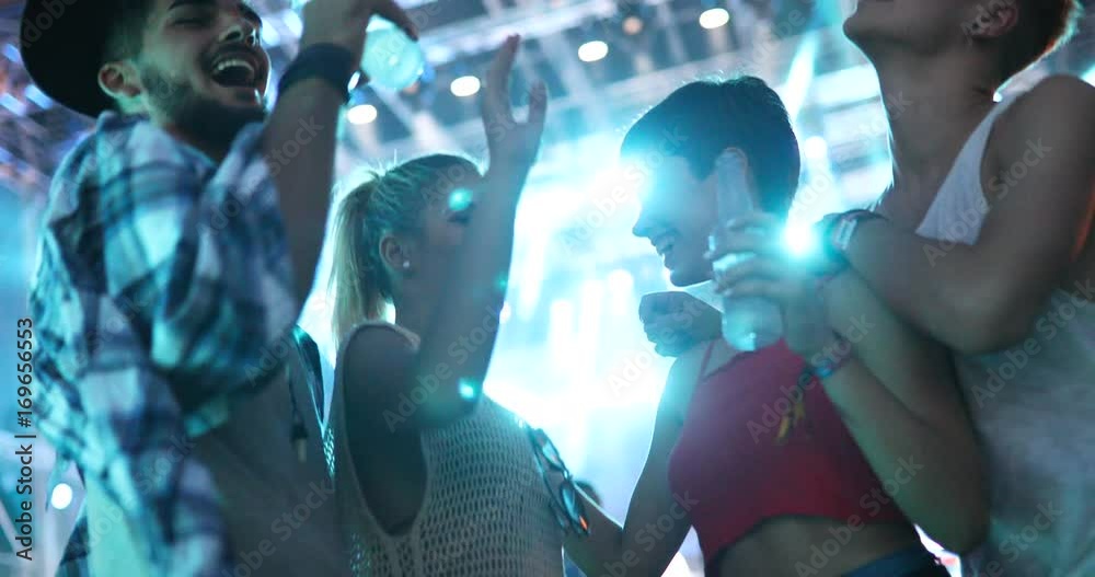 Friends partying in club at night