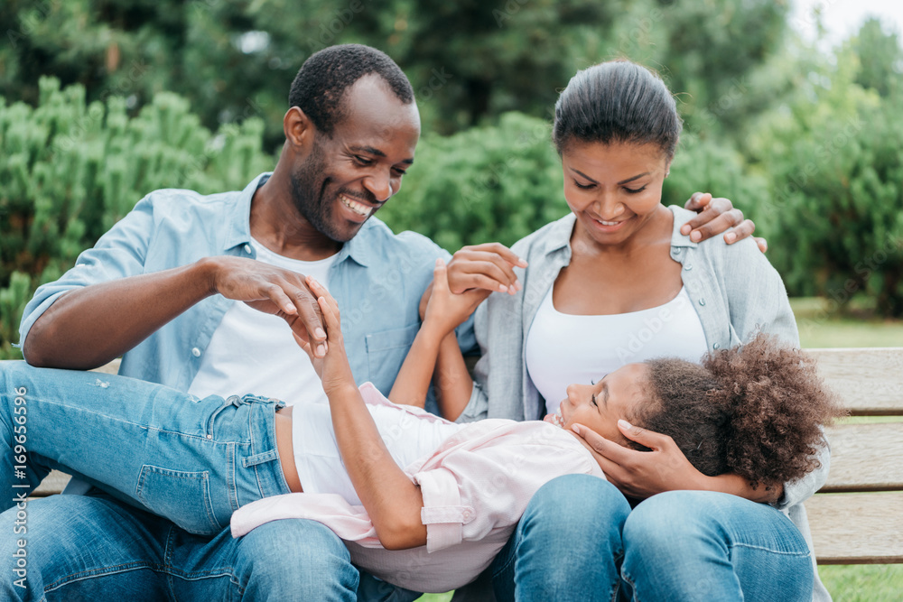 african american family resting on bench african american family resting on bench