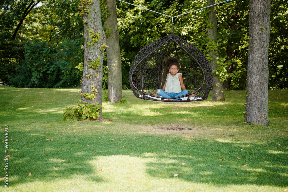 Fototapeta premium kid swinging on swing in park