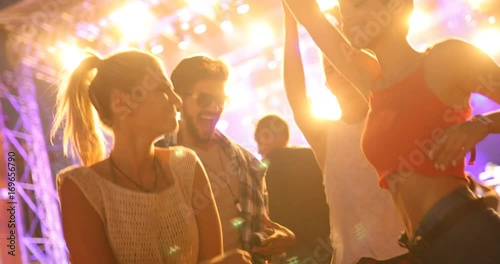 Friends dancing at festival outdoors