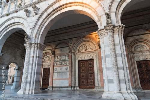 Details of the Romanesque Facade and bell tower of St. Martin Cathedral in Lucca, Tuscany. 