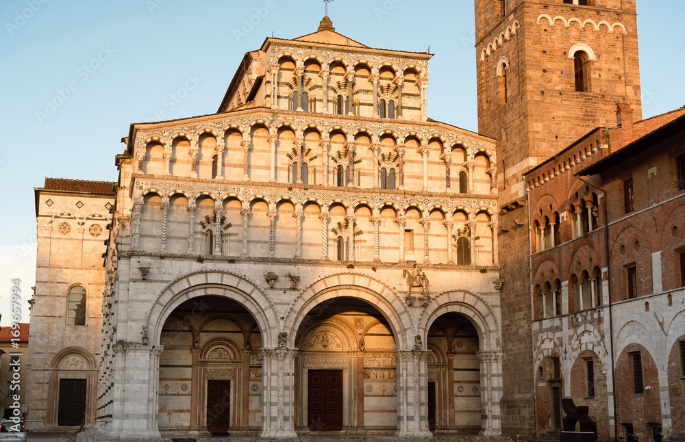 Romanesque Facade and bell tower of St. Martin Cathedral in Lucca, Tuscany. It contains most precious relic in Lucca, Holy Face of Lucca (Italian: Volto Santo di Lucca)