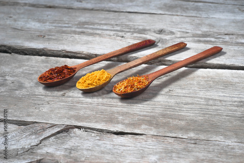 Various colorful spices on wooden table photo