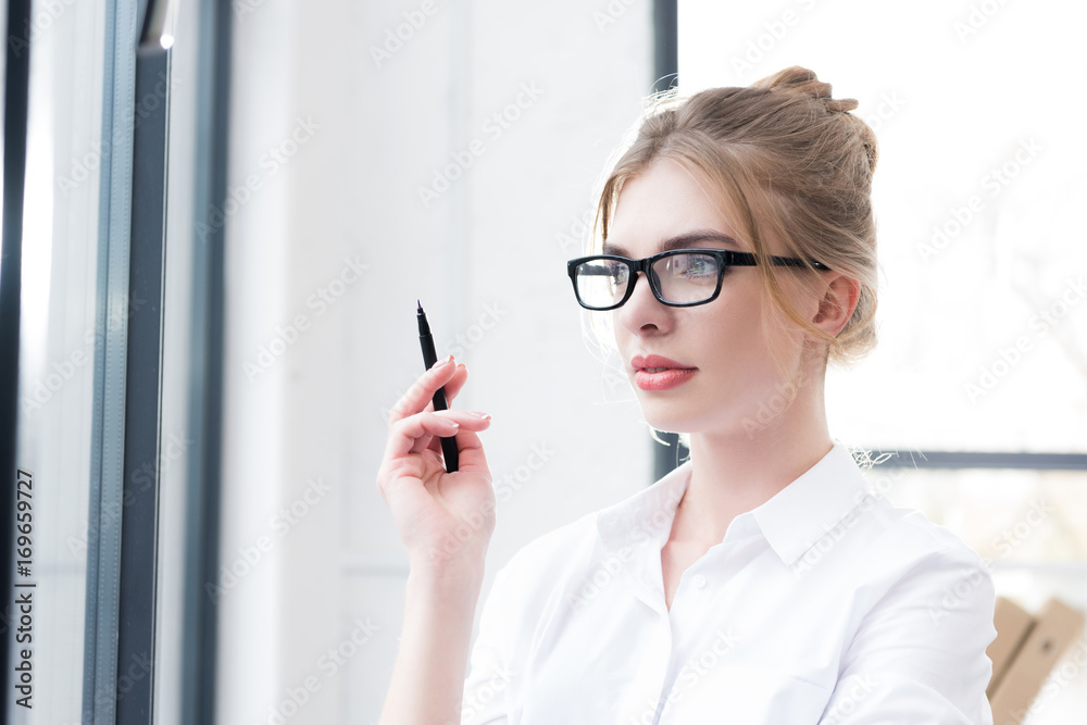 thoughtful businesswoman in eyeglasses