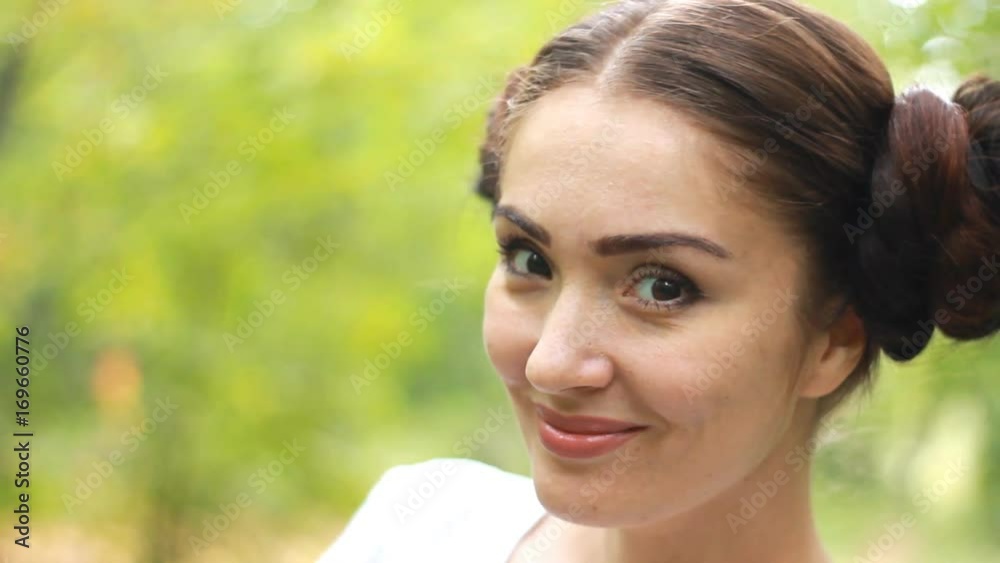 Smiling girl showing different emotions. Winks and looks at the camera. Smiling girl showing different emotions. Winks and looks at the camera.