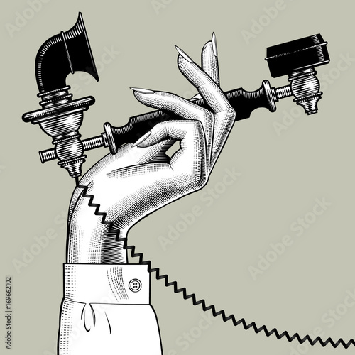 Woman's hand with retro black phone