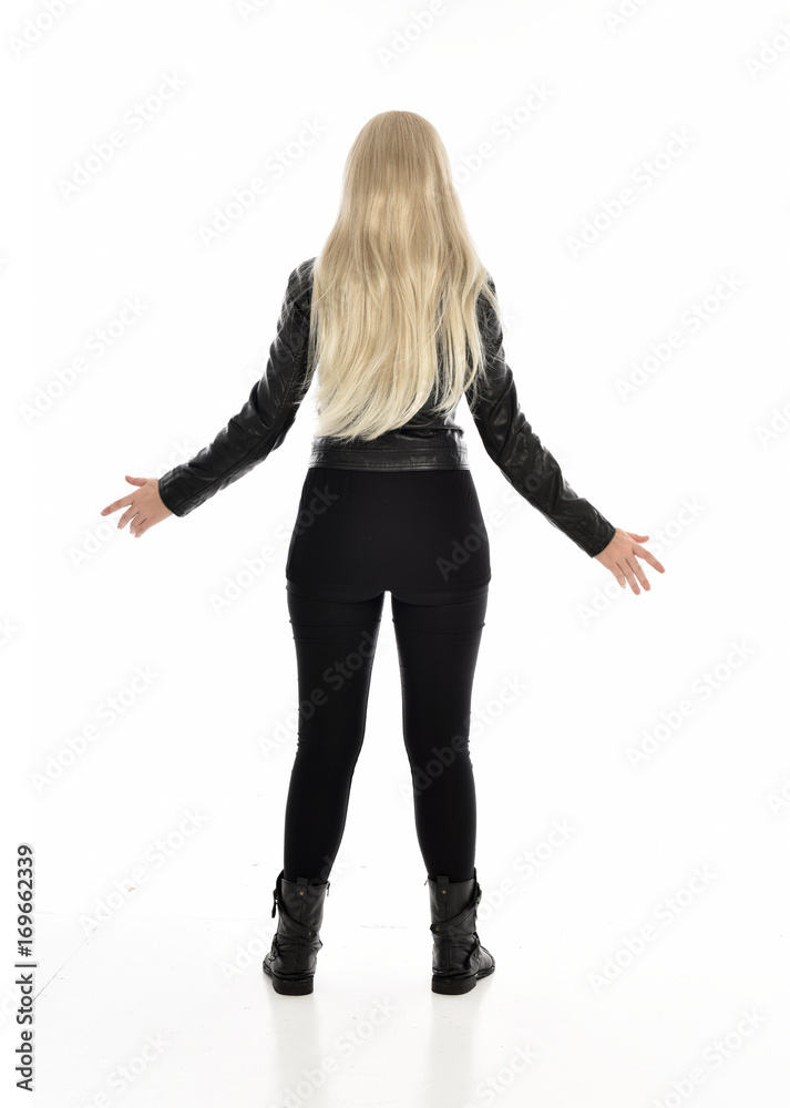 full length portrait of blonde girl wearing black leather outfit, standing pose on white background. full length portrait of blonde girl wearing black leather outfit, standing pose on white background.