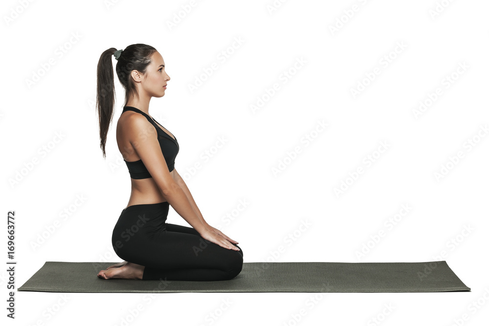 Woman exercising on yoga mat. Isolated on white. Woman exercising on yoga mat. Isolated on white.
