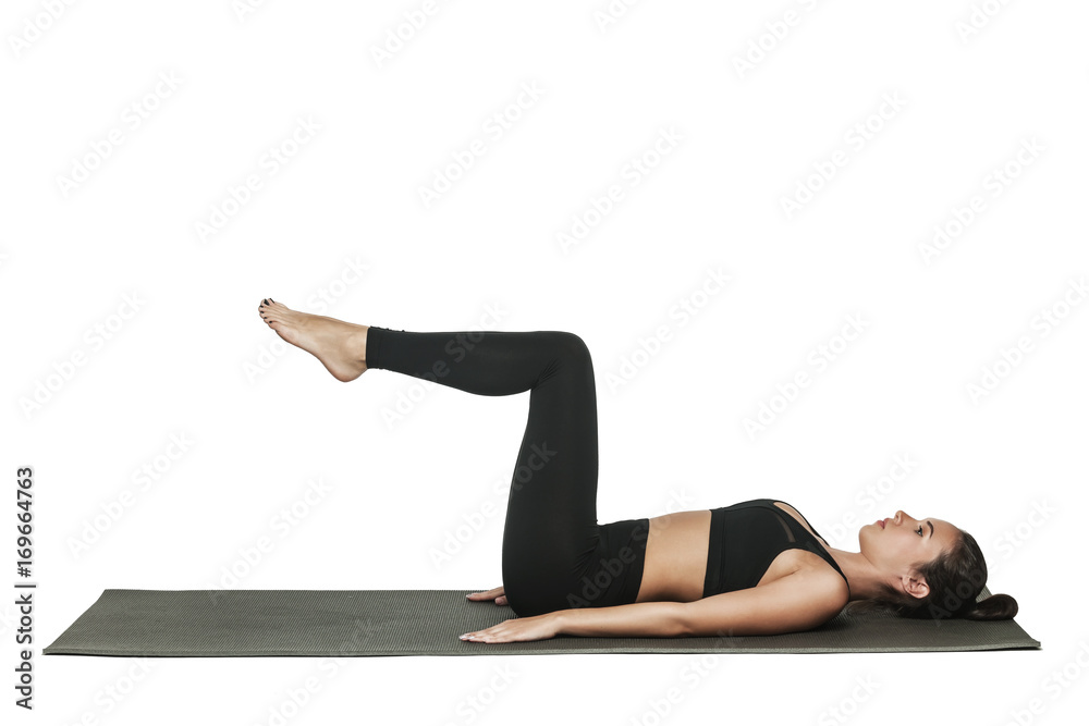 Woman exercising on yoga mat. Isolated on white. Woman exercising on yoga mat. Isolated on white.