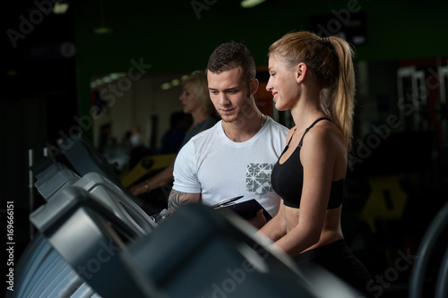 Cute blonde woman working with fitness coach