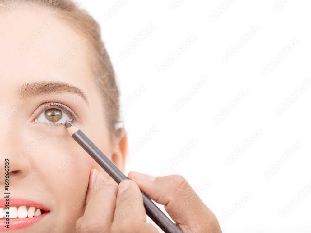 Closed up of face Young caucasian beautiful girl with hand applying make-up by make-up artist,isolated on white ,copy space Closed up of face Young caucasian beautiful girl with hand applying make-up by make-up artist,isolated on white ,copy space
