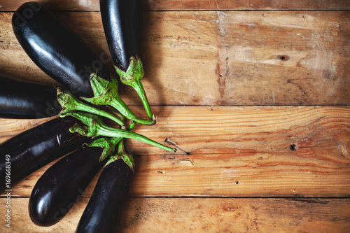 Six ripe eggplant stacked fan on planed boards photo