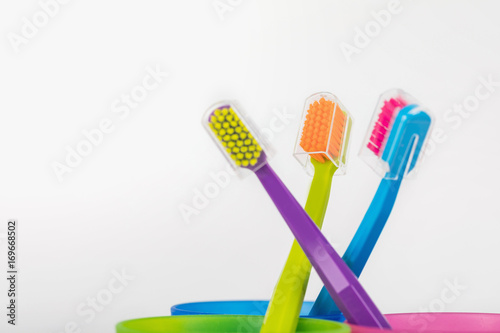 New color ultra fine toothbrushes in colorful glasses. Dental Industry. various types of toothbrushes. Beautiful smile concept. Whitening. Tooth care. Teeth healthy concept.