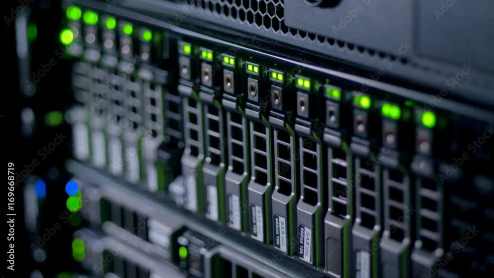 Vertically installed fast HDDs with glowing indicators. 