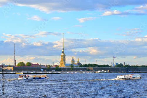 Pleasure boats floating on the Neva river on the background of the Peter and Paul fortress in summer in Saint-Petersburg