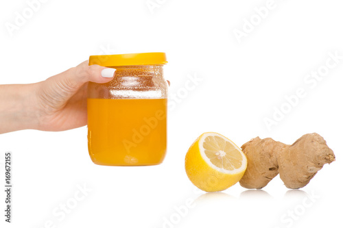 Female hand holding honey lemon ginger tea