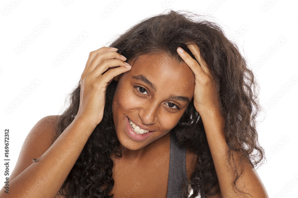 Obraz premium beautiful and happy dark skinned young girl on white background