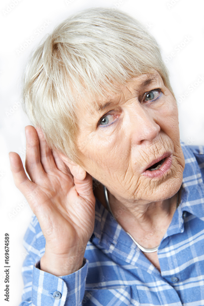 Studio Shot Of Senior Woman Suffering From Deafness Studio Shot Of Senior Woman Suffering From Deafness