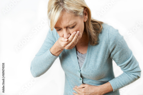 Studio Shot Of Mature Woman Suffering From Nausea