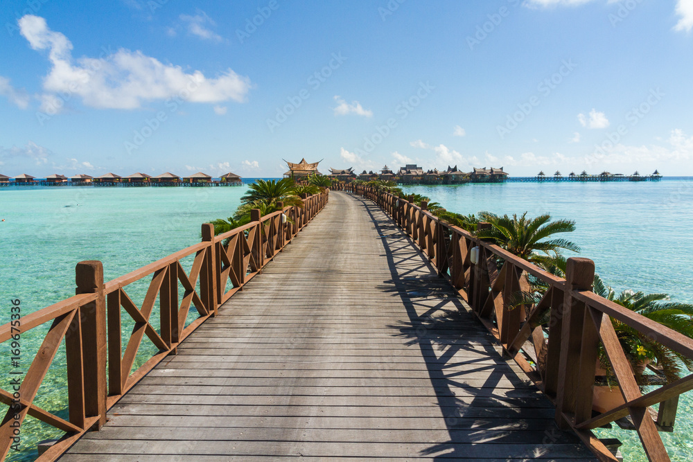 Bridge and Bungalows with a blue ocean, paradise island, mabul island in borneo