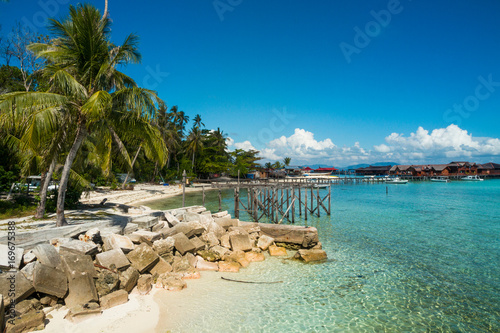 Fototapeta Naklejka Na Ścianę i Meble -  White sand on the beach and palm trees, paradise island, mabul island in borneo