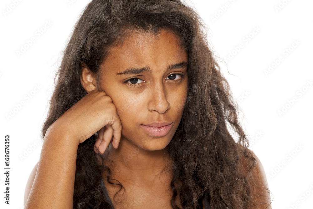 Lonely and sad dark skinned young girl on white background Lonely and sad dark skinned young girl on white background