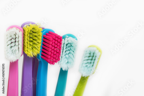 New and used color ultra fine toothbrushes in colorful glasses. Dental Industry. various types of toothbrushes. Beautiful smile concept. Whitening. Tooth care. Teeth healthy concept.