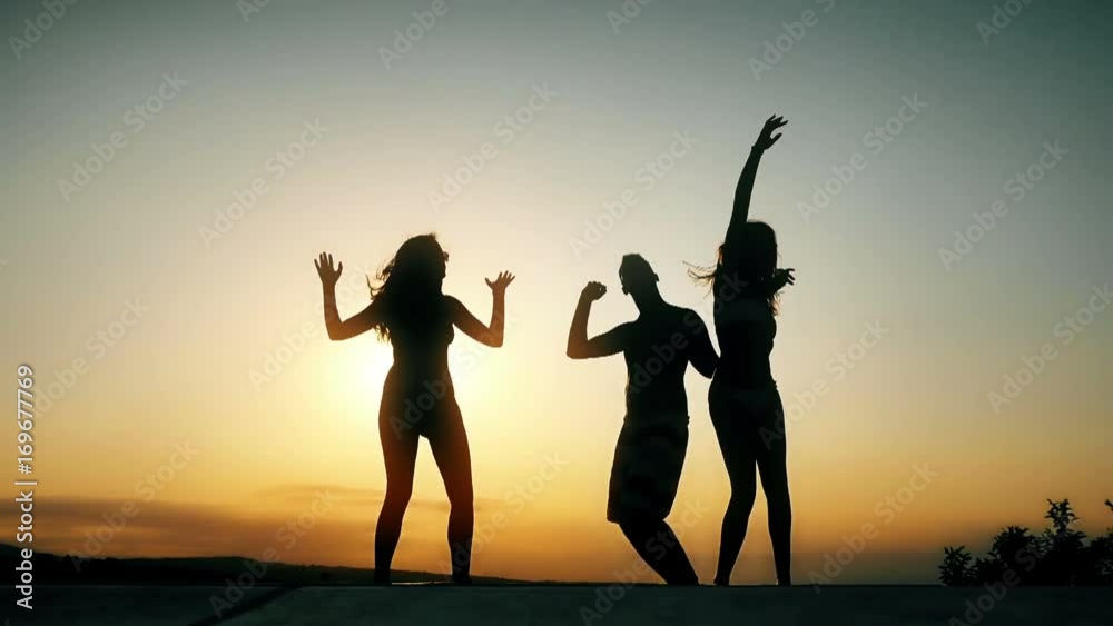 Group of happy young people enjoying summer sunset Group of happy young people enjoying summer sunset