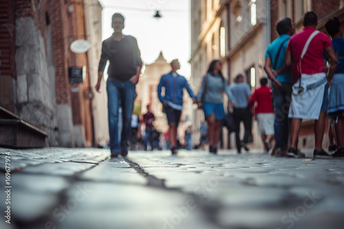 Blurred people walking and standing on the street