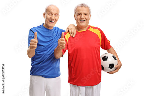 Two elderly soccer players making thumb up signs