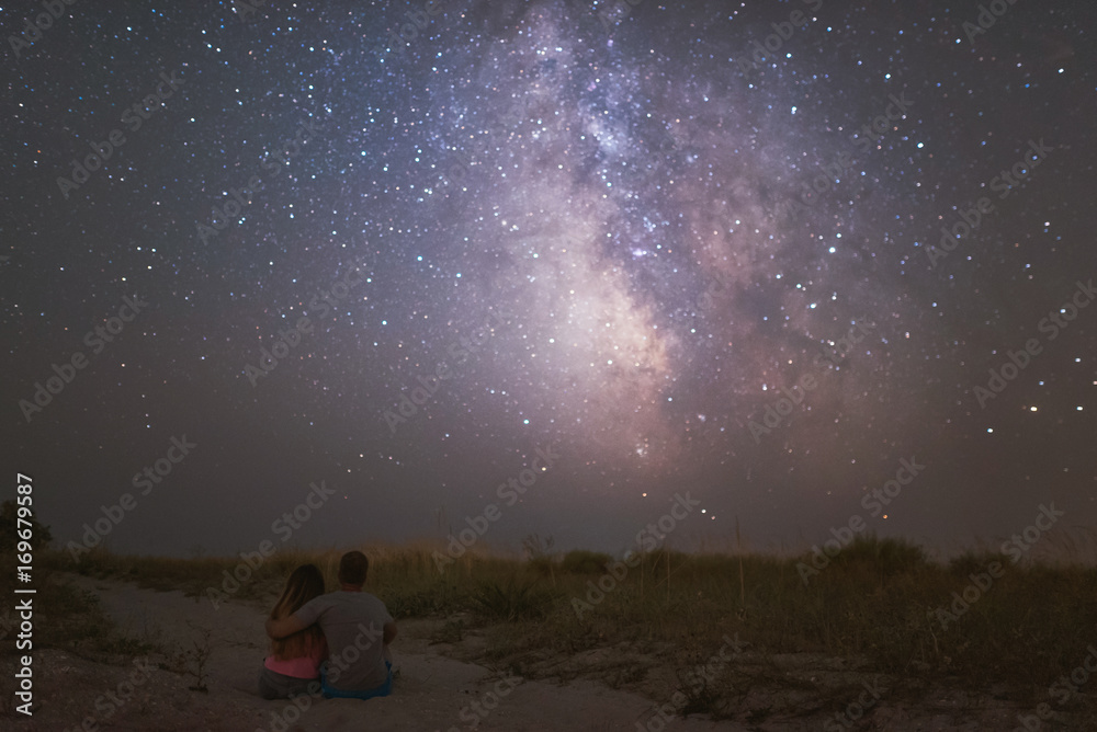 couple in love under stars of Milky Way Galaxy 