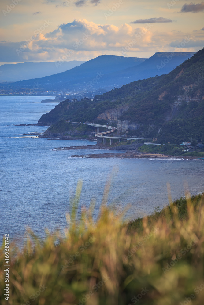 Stanwell Park and Stanwell Beach from the Bald Hill Lookout along the Illawarra Range & S Curve bridge on the New South Wales coastline, Australia with an elevation of approximately 300 meters.
