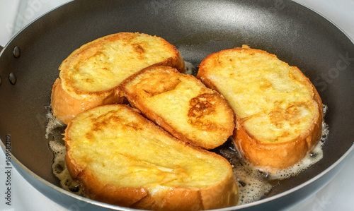 Toasts are fried in a frying pan