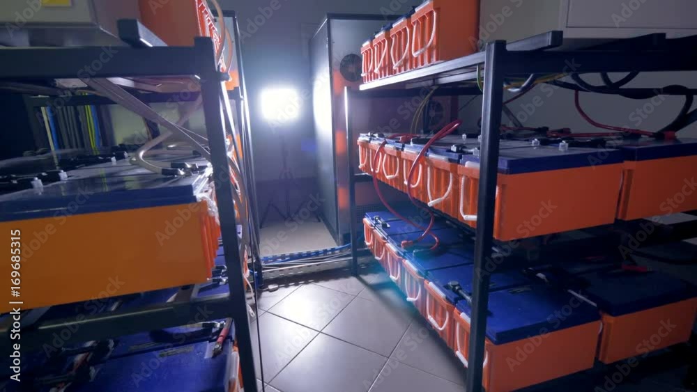 Metal racks storing industrial batteries for data storage equipment. 