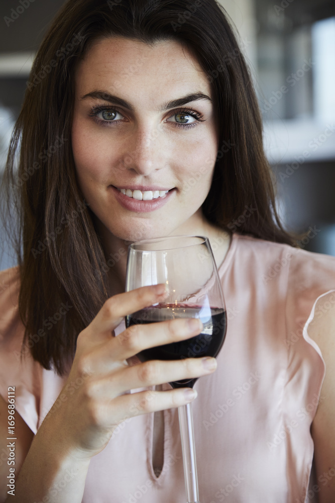 Portrait of beautiful woman enjoying red wine