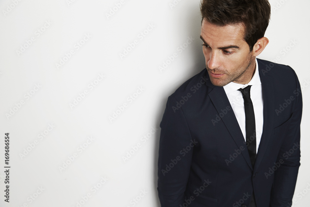 Businessman in smart suit looking away in studio Businessman in smart suit looking away in studio