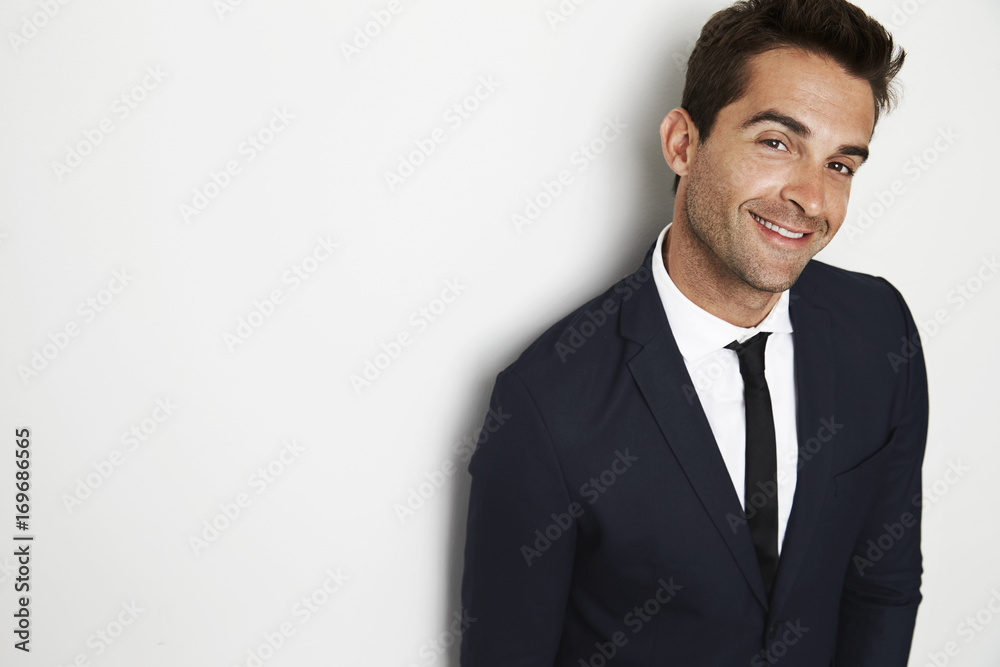 Confident businessman in smart suit looking to camera