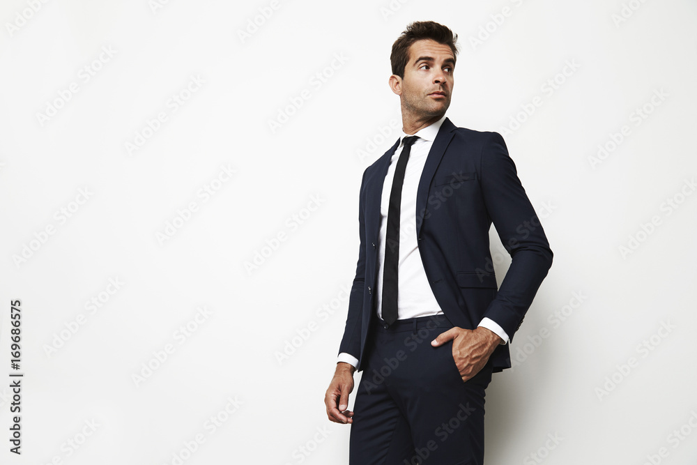 Handsome businessman in sharp suit looking away Handsome businessman in sharp suit looking away