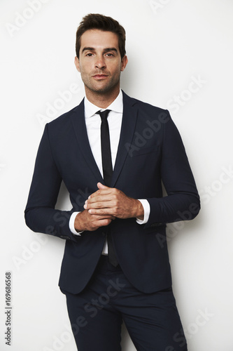 Portrait of handsome dude in suit, studio