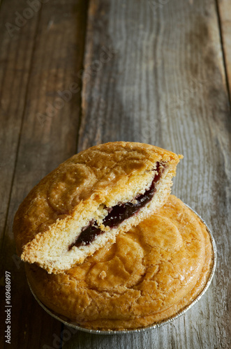 Slice of a delicious basque cake filled with cherries put on wooden boards.