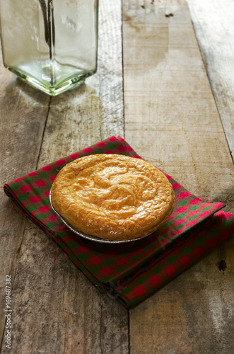Delicious basque cake put on a fabric with tile and wooden boards.