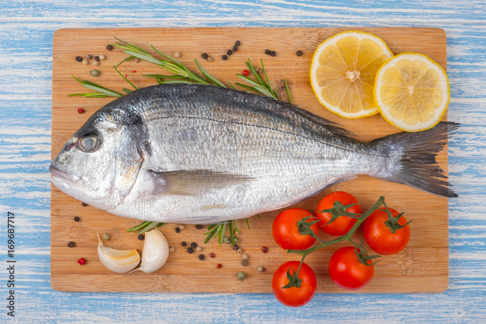 Fresh dorado on blue wooden background Fresh dorado on blue wooden background