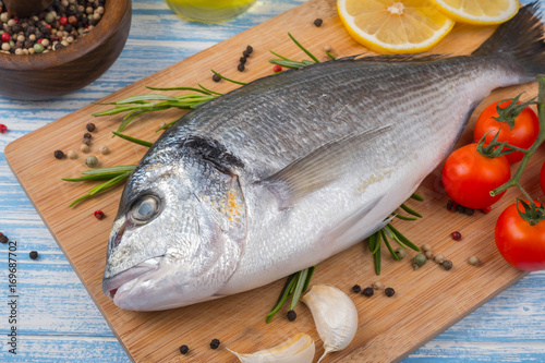 Fresh dorado on blue wooden background