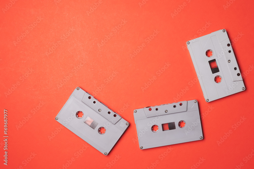 Audio cassette tapes on a orange background. Free space for text Audio cassette tapes on a orange background. Free space for text