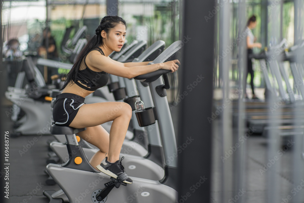 Portrait of pretty girl training on special sport equipment in gym Portrait of pretty girl training on special sport equipment in gym