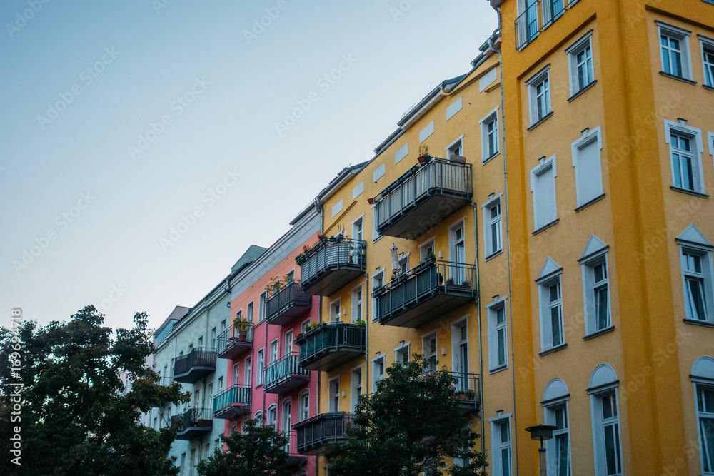 orange, pink and grey facaded buildings in a row at berlin